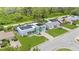 Beautifully landscaped property with solar panels, complemented by a lush green lawn and charming turquoise accents at 3519 Richboro Dr, Holiday, FL 34691