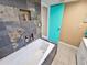 Bathroom featuring a luxurious bathtub with tile surround and modern fixtures at 3519 Richboro Dr, Holiday, FL 34691