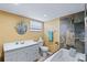 Bathroom featuring stylish tile shower and tub, complete with modern vanity and fixtures at 3519 Richboro Dr, Holiday, FL 34691