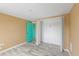 Bedroom with modern floors, double door closet, and accent teal door at 3519 Richboro Dr, Holiday, FL 34691