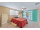 A bright bedroom with neutral walls, ceiling fan, and pool views creates a serene and inviting retreat at 3519 Richboro Dr, Holiday, FL 34691