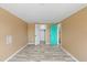 This is a tan bedroom with woodgrain floors, an open closet, and a door leading to another room at 3519 Richboro Dr, Holiday, FL 34691