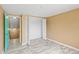This is a simple bedroom with woodgrain flooring, a walk in closet, and a door leading to the hall and stairs at 3519 Richboro Dr, Holiday, FL 34691