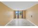 A tan bedroom is brightened by large windows that are covered by long gray curtains and framed by a white trim at 3519 Richboro Dr, Holiday, FL 34691