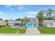 Well maintained single-Gathering home, showcasing a lush lawn and charming turquoise accents, perfect for a Gathering at 3519 Richboro Dr, Holiday, FL 34691