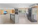 Updated kitchen with an island, black appliances, and access to the connected living area for easy entertaining at 3519 Richboro Dr, Holiday, FL 34691