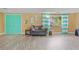 Inviting living room with laminate flooring and vibrant doors, offering a comfortable and stylish living space at 3519 Richboro Dr, Holiday, FL 34691