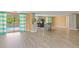 Open concept living area featuring a kitchen, views of the pool, and neutral paint is ideal for seamless entertaining at 3519 Richboro Dr, Holiday, FL 34691