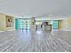 Bright living space with modern flooring flows into the kitchen area, providing an open and airy atmosphere at 3519 Richboro Dr, Holiday, FL 34691