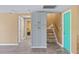 Open-concept living space with wood-look flooring, built-in cabinet, and staircase at 3519 Richboro Dr, Holiday, FL 34691