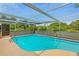 This property has a screened-in pool with blue water and a diving board at 3519 Richboro Dr, Holiday, FL 34691