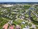 Aerial view showcasing a residential neighborhood dotted with ponds, canals, and mature trees and manicured lawns at 358 Highland Shores Dr, Ellenton, FL 34222