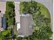 Aerial view of the property showing the roof, driveway, and surrounding greenery at 358 Highland Shores Dr, Ellenton, FL 34222