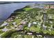 Beautiful aerial view of waterfront homes with private docks and lush, mature landscaping near the bay at 358 Highland Shores Dr, Ellenton, FL 34222