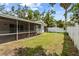 Backyard of the property with a screened porch visible, offering outdoor living at 358 Highland Shores Dr, Ellenton, FL 34222