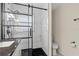 Modern bathroom featuring a sleek glass shower with a marble tile surround and a black shower pan at 358 Highland Shores Dr, Ellenton, FL 34222