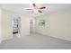 Bedroom with carpet floor, cream walls, ceiling fan, and an en-suite bathroom at 358 Highland Shores Dr, Ellenton, FL 34222