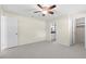 Bedroom featuring carpet flooring, cream walls, a ceiling fan, and a door leading to an en-suite bathroom at 358 Highland Shores Dr, Ellenton, FL 34222