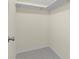 Walk-in closet offering ample storage with neutral walls, carpet flooring, and a single bar for hanging clothes at 358 Highland Shores Dr, Ellenton, FL 34222