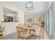 Bright dining room with a round table, four chairs, and a view into the modern kitchen at 358 Highland Shores Dr, Ellenton, FL 34222