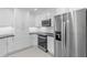 Modern kitchen with stainless steel appliances, bright white cabinets and black countertops at 358 Highland Shores Dr, Ellenton, FL 34222