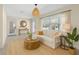 Cozy living room with a neutral color palette, sofa, and natural light from a large window at 358 Highland Shores Dr, Ellenton, FL 34222