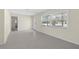 Spacious living room featuring carpeting, a bright window and a door that opens to the outside at 358 Highland Shores Dr, Ellenton, FL 34222