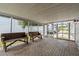 Screened patio with brick floor, wooden benches, and outdoor view at 358 Highland Shores Dr, Ellenton, FL 34222