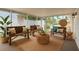 Sunroom with wooden benches, bright light, and neutral decor at 358 Highland Shores Dr, Ellenton, FL 34222