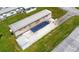 Home sits on a well-maintained lot with green grass, concrete driveway and mature landscaping at 37302 Carol Ave, Zephyrhills, FL 33542