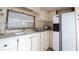 The kitchen has white cabinets, practical appliances, a view from a window and a sink at 37302 Carol Ave, Zephyrhills, FL 33542