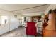 Bright living room area features wood furniture, carpet flooring, and ample natural light at 37302 Carol Ave, Zephyrhills, FL 33542
