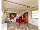 Spacious living room featuring carpet and a television set inside a wood entertainment center at 37302 Carol Ave, Zephyrhills, FL 33542