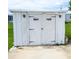 White shed with decorative accents on the doors and sconces at 37302 Carol Ave, Zephyrhills, FL 33542