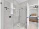 Modern bathroom features glass-enclosed shower with tile surround, chrome fixtures, and wood-look flooring at 3800 Night Star, Odessa, FL 33556