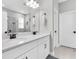 Well-lit bathroom with double vanity, white cabinets, gray countertops, and chrome fixtures at 3800 Night Star, Odessa, FL 33556
