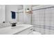 Bright bathroom features a marble countertop, single vanity, and a shower-tub combination with curtain at 3800 Night Star, Odessa, FL 33556