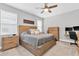 Spacious bedroom with a wooden bed frame, ceiling fan, and two windows for plenty of light at 3800 Night Star, Odessa, FL 33556
