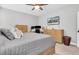 Primary bedroom boasts wood furniture, soft carpet, ceiling fan, and large-screen television at 3800 Night Star, Odessa, FL 33556