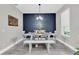 Bright dining room features a white table set for six with bench seating and stylish decor at 3800 Night Star, Odessa, FL 33556