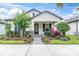 Beautiful home facade showcasing a neatly landscaped front yard with vibrant plants and a paved walkway at 3800 Night Star, Odessa, FL 33556