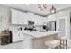 Modern kitchen with white cabinets, stainless steel appliances, and a breakfast bar at 3800 Night Star, Odessa, FL 33556