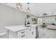 Contemporary kitchen featuring white cabinetry and an open layout to living room at 3800 Night Star, Odessa, FL 33556