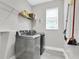 Laundry room features modern washer and dryer with shelving for storage of detergents and cleaning supplies at 3800 Night Star, Odessa, FL 33556