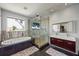 Bright bathroom with glass shower, modern vanity, soaking tub, and outside views at 3956 Versailles Dr, Tampa, FL 33634