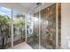 Bathroom with garden view from glass shower and modern fixtures with stone shower at 3956 Versailles Dr, Tampa, FL 33634