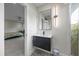 Modern bathroom with designer vanity, sleek mirror, and an adjacent bedroom view at 3956 Versailles Dr, Tampa, FL 33634