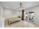 Bright bedroom features a ceiling fan and sliding glass doors to a patio with water views at 3956 Versailles Dr, Tampa, FL 33634