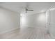 A spacious bedroom with light wood floors, white trim and ceiling fan at 3956 Versailles Dr, Tampa, FL 33634