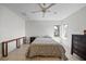 Simple bedroom with hardwood floors, ceiling fan, two windows and natural light at 3956 Versailles Dr, Tampa, FL 33634